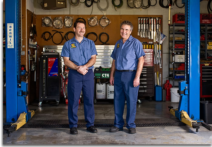 Haik and Kurt standing in auto shop